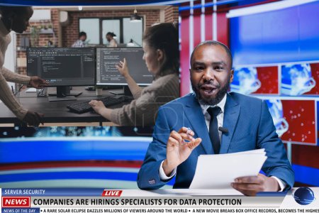 Photo for Journalist talks of data protection growth among big companies, news reportage about IT programming industry jobs. African american man presenter covering technology newscast, tv host. - Royalty Free Image
