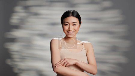 Photo for Female model promoting skincare products and cream, creating skincare ad campaign for nourishing uplifting cosmetics. Beautiful happy woman posing on camera to advertise imperfections. - Royalty Free Image