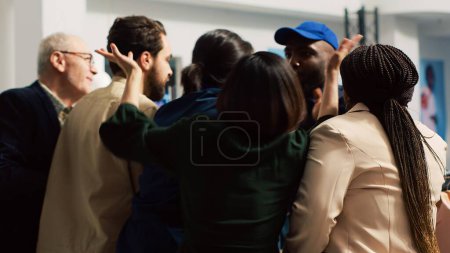 Photo for Out of control crowd of mad shoppers pushing through barrier on black friday event, trying to get access into shopping center. Fighting inside clothing store to get best discounts. Handheld shot. - Royalty Free Image