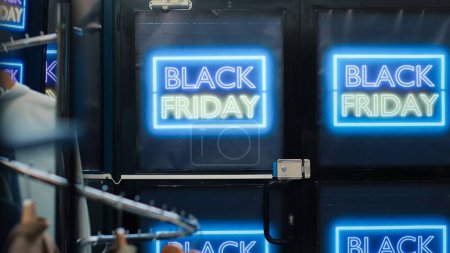 Photo for Front door of clothing shop open on black friday promotions day, special offers for merchandise and discounted items. Signs and banners showing big sales in retail store boutique. - Royalty Free Image
