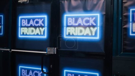Photo for Black friday shopping retail store design. Shopping center front door decorated with neon promotional banners to attract attention of potential clients during seasonal sales event. - Royalty Free Image
