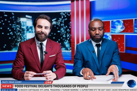 Photo for Diverse hosts announcing new food festival and providing entertainment leisure activity on midnight talk show. Media journalists giving updates on recent event in the city, tv broadcast. - Royalty Free Image