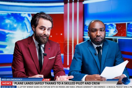 Photo for Newscasters team talk about pilot protecting passengers on airplane flight by landing safely, flying hero. Diverse tv journalist working on daily headlines broadcasting, early talk show. - Royalty Free Image