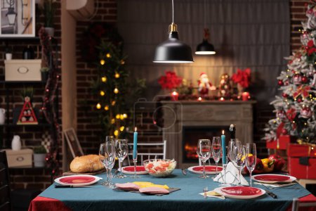 Photo for Christmas festive dinner on winter holiday, dining table with seasonal food and xmas decorations. Cozy decorated home with christmas tree and lights for traditional family party. - Royalty Free Image