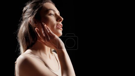 Photo for Woman with glamourous style doing beauty campaign and posing on camera for skincare products ad. Young female model acting confident and gentle, being sensual with beauty routine. - Royalty Free Image