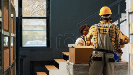 Photo for Team of employees preparing boxes with products in storehouse, packing merchandise in cardboard boxes. People checking packages with retail store products and supplies, stock distribution. - Royalty Free Image
