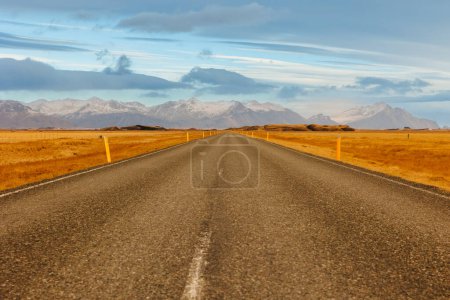 Photo for Lovely arctic surroundings, long road concept and highway within the icelandic region. Huge mountain range afar and roadway in nordic paradise, amazing countryside lands near route. - Royalty Free Image
