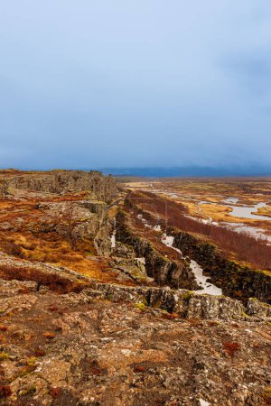 Photo for Rocky hills nordic landscape in thingvellir national park, beatufiul natural scenery with rock formations and valley with cliffs. Majestic icelandic landmarks with mountain wall, highland. - Royalty Free Image