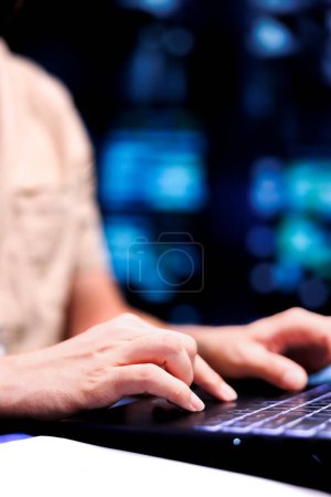 Photo for Close up shot of serviceman dealing with data center system failures, using laptop to order servers with high availability features to minimize downtime and prevent crashes - Royalty Free Image