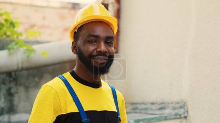 Photo for Revealing portrait shot of happy trained engineer with tablet checking refrigerant levels in condenser while using manometers to accurately measure the pressure in HVAC system - Royalty Free Image