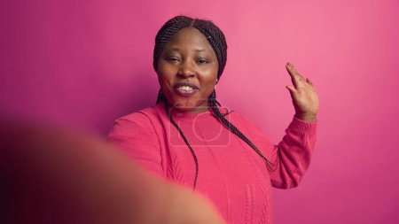 Photo for POV of woman speaking on video call utilising an internet videoconference chat for a remote communication. Young adult having a good time at an online teleconference meeting in the studio. - Royalty Free Image