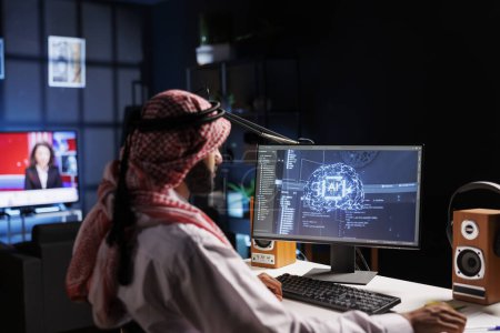 Téléchargez les photos : Un ingénieur arabe examine les données et assure la cybersécurité. Compétent en technologie de l'information et en programmation, il développe des logiciels pour l'apprentissage automatique et l'informatique quantique. - en image libre de droit