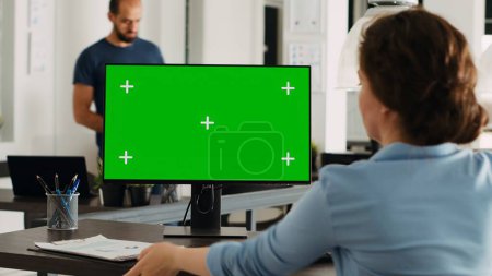 Photo for Manager working with isolated greenscreen on computer at workstation, looking at chromakey display with mockup template on desk. Businesswoman using pc in coworking space. - Royalty Free Image