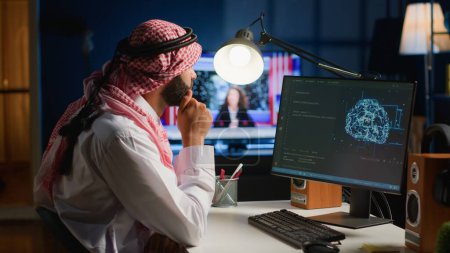 Photo for Computer operator updating artificial intelligence neural networks, writing complex binary code scripts. Outsourcing arabic freelancer in personal office uses digital device programming to upgrade AI - Royalty Free Image