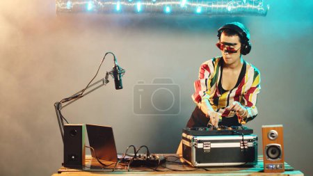 Photo for Woman performer hiding from police after seeing lights at nightclub, trying to stop techno party after hearing sirens. Female DJ running from law enforcement raid. Tripod shot. - Royalty Free Image