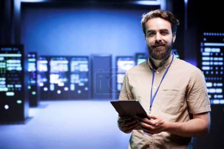 Portrait of technician making sure servers in cloud computing business service are correctly equipped, to provide redundancy and automatic failover of clusters to minimize failure of hardware