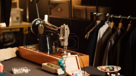 Photo for Fashion atelier sewing machine and tools on workshop table, luxury tailoring design and industrial materials. Workstation with fabric and pins for clothes manufacturing process. Close up. - Royalty Free Image