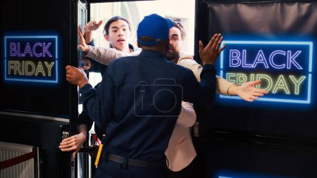 Photo for People tired of waiting for black friday, diverse group of shoppers arguing with security agent to open door. Customers preparing to enter clothing store at mall, bargain hunting. - Royalty Free Image