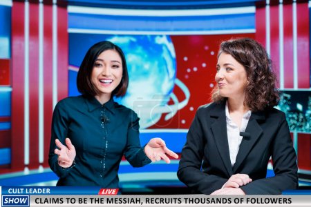 News team discuss latest events on morning show, presenting information about fanatic person claimind to be messiah and recruiting followers. Two women in newsroom broadcasting live madness.