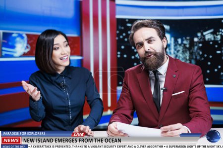 Photo for Presenters reveal natural discovery of new island appearing on ocean coast, creating paradise place for explorers. Media newscasters team broadcasting live daily events in newsroom. - Royalty Free Image