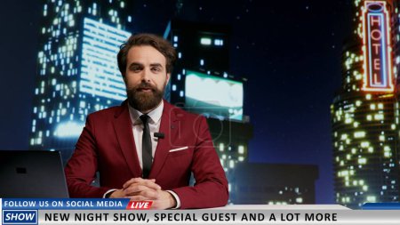 TV host introducing new night talk show late on television program, promising interesting guests and latest media news topics in newsroom. Man journalist presenting his broadcast.