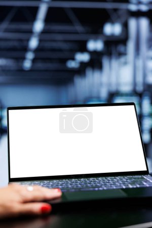 Photo for Close up shot of mock up laptop used by admin in server room delivering massive computing power, capable of processing and storing vast amounts of data and controlling network resources - Royalty Free Image