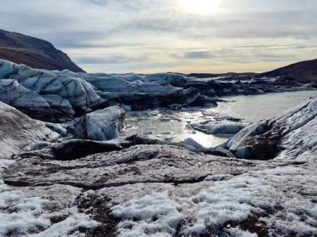 Large nordic vatnajokull ice cap in iceland, amazing massive glacier lagoon with ice blocks colored and cracked. Frozen floating icebergs in frosty winter landscape and natural setting.