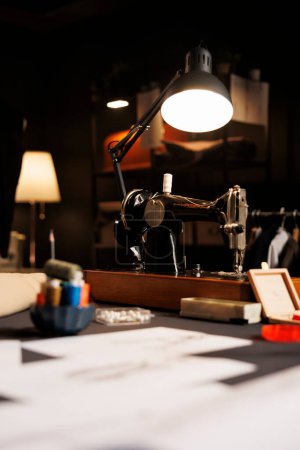 Photo for Focus on industrial sewing machine in tailoring studio used for cutting textile materials and embroidery. Professional premium atelier shop workspace filled with dressmaking instruments - Royalty Free Image