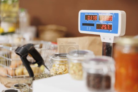 Photo for Close up shot of eco friendly checkout counter displaying weighing scale, barcode scanner, and variety of fresh sustainable products in glass containers. - Royalty Free Image