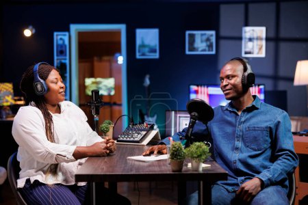 During this talk show, a male host interviews with a female influencer using a professional microphone. Together, they create engaging creative content for their online audience.