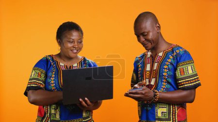Photo for Married people doing online shopping on laptop, using internet site to type debit card information for electronic banking purchase. Joyful woman buying items on store webpage, web transaction. - Royalty Free Image