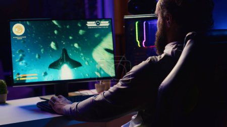 Man arriving at home, ready to relax by shooting asteroids in spaceship flying singleplayer game. Gamer sitting in gaming chair, navigating universe in simulation game, close up