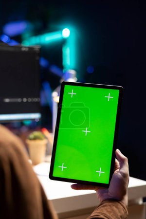 Cybersecurity expert using green screen tablet to secure company servers from virus attacks. IT remote employee writing code, building firewalls protecting data using mockup portable digital device