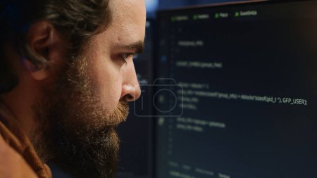 Photo for Software engineer concerned, concentrating on finding bugs while coding on computer, extreme close up. Troubled IT professional frowning while looking at screen, confused by script errors, camera A - Royalty Free Image