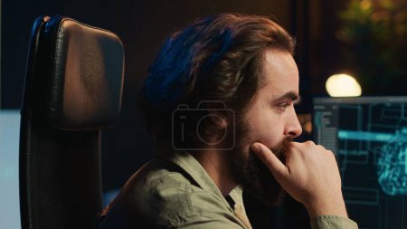 Photo for Computer scientist updating artificial intelligence machine learning algorithm, writing binary code scripts. IT specialist in apartment office uses programming to upgrade AI, camera A close up - Royalty Free Image