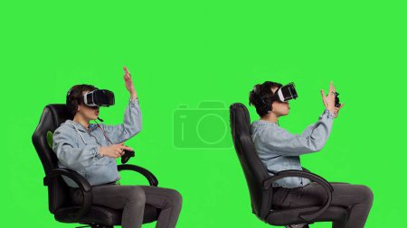 Photo for Disappointed player feeling angry about lost tournament online on virtual reality cyberspace, losing gaming championship against greenscreen backdrop. Woman getting furious after failure. Camera B. - Royalty Free Image