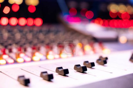 Photo for Motorized faders and sliders used in music production industry, soundboard pads station for editing and mixing tracks. Empty control room in professional studio, mix and master equipment. Close up. - Royalty Free Image