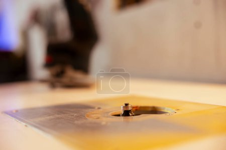 Photo for Close up shot of edge jointer in carpenter studio used for precision cutting of wood blocks, making wooden objects. Focus on router planer used in woodworking for smoothing out panels - Royalty Free Image