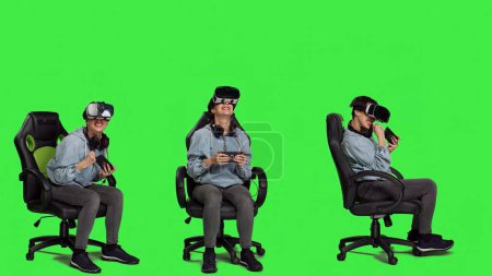 Happy gamer winning video games tournament with vr glasses, playing mobile gaming championship using her smartphone and virtual reality interactive headset. Greenscreen backdrop. Camera A.