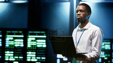 Photo for IT developer setting up data center advanced firewalls, intrusion detection systems and regular security updates. Cybersecurity expert preventing hacking, malware, and DDoS attacks - Royalty Free Image