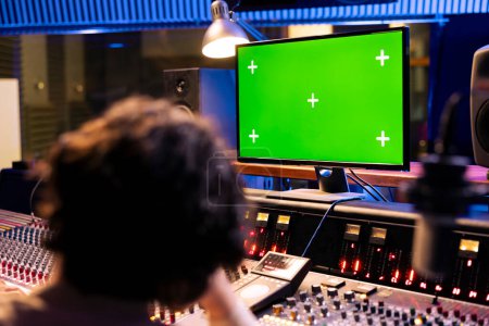 Photo for Artists recording and editing music to produce a new album in control room professional studio, working together to do mix and master on music. Team of musicians creating new tracks. - Royalty Free Image