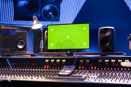 Photo for Empty control room with greenscreen on monitor and panel board, professional studio used for recording and editing tracks. Audio console helping with mixing and mastering music. - Royalty Free Image