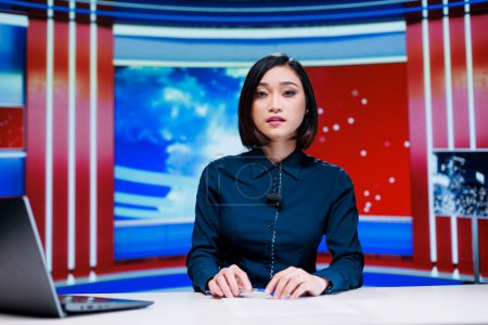 Photo for News anchor talking about politics on live broadcast show, presenting daily events and entertainment reportage. Asian newscaster covering all important stories, television network. - Royalty Free Image