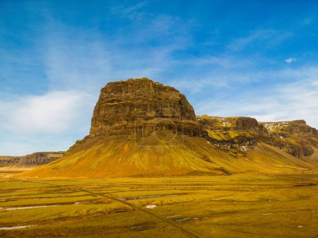 Photo for Aerial view of massive mountain range in iceland, huge slopes with brown rocks in nordic highlands scenery. Beautiful icelandic landscape with large hilltop around frosty pastures. - Royalty Free Image