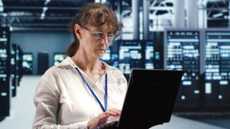 Knowledgeable supervisor looking around advanced data center, preparing to start comission on damaged high tech blade servers in order to ensure optimal operations