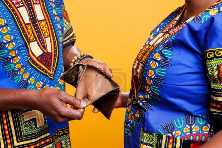 Afroamerikaner mit offenem Portemonnaie ohne Geld in Nahaufnahme. Gebrochenes schwarzes Paar ohne Ersparnisse, Bargeld im leeren Portemonnaie und Finanzkrise im Familienkonzept