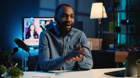 African american content creator using professional recording equipment to film channel intro for online streaming platforms. Internet star greets fanbase, presenting today video topic