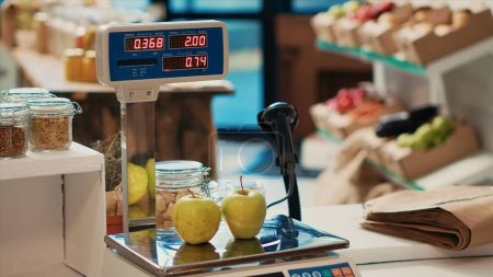 Electronic scale in zero waste grocery store to weight bulk items and fresh organic locally grown produce. Farmers market selling food industrial solvents or synthetic additives, weighing machine.