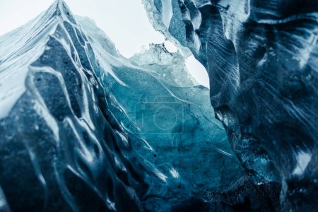 Vatnajokull ice mass at scandinavian location, containing big fragments of ice inside gap used for glacier hiking. Glacial blocks inside caves and passageways, climate change theme.