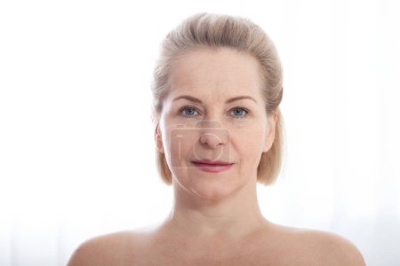 Portrait beautiful middle-aged woman close up. Skin care for wrinkled face, anti-aging facelift treatment. Facial skincare and contouring. Beauty and make-up